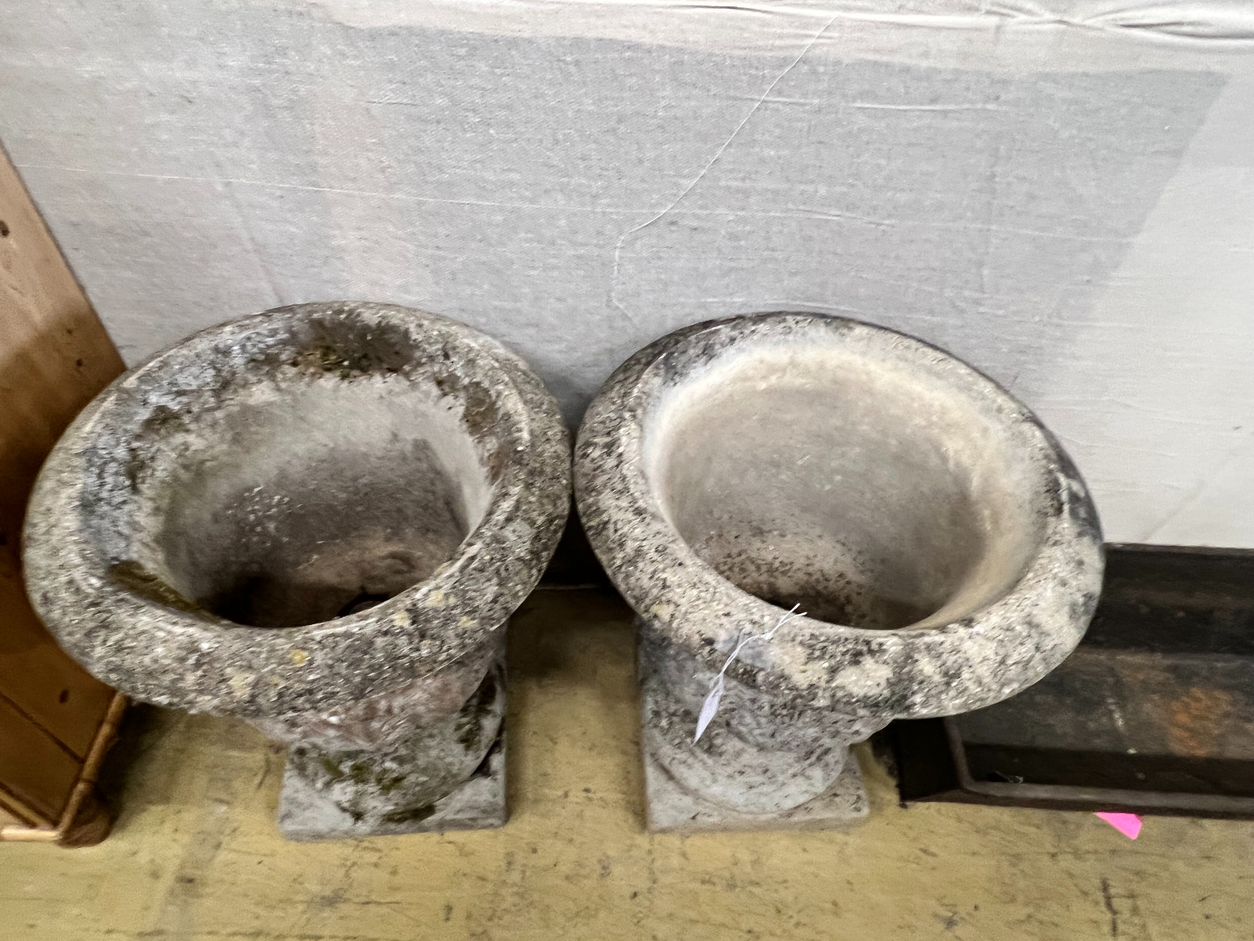 A pair of reconstituted stone acanthus moulded circular campana garden urns, diameter 49cm height 61cm
